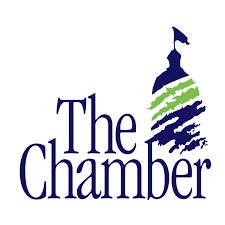 A logo for the chamber of commerce with a flag on top of a building.