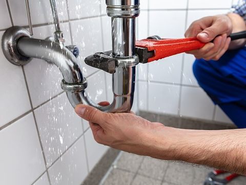 Plumber Repairing A Leaked Pipe — Brian Cook Plumbing in Coffs Harbour, NSW