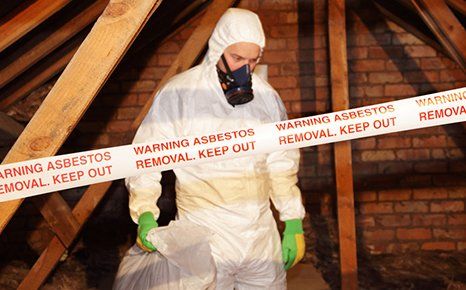 Asbestos surveyors in his safety uniform