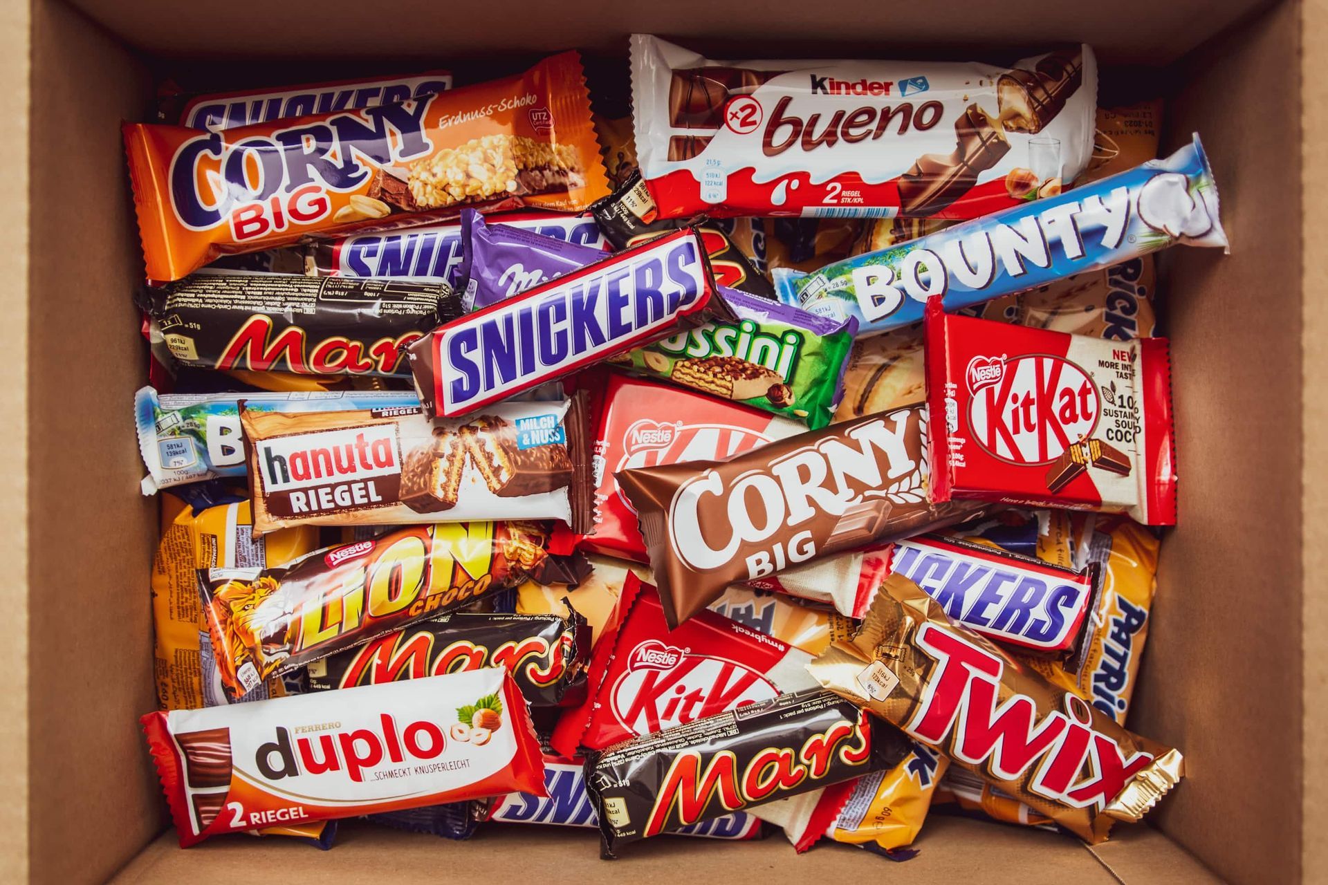 A box filled with lots of different types of chocolate bars.