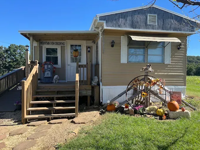 A mobile home with a porch and stairs decorated for halloween.