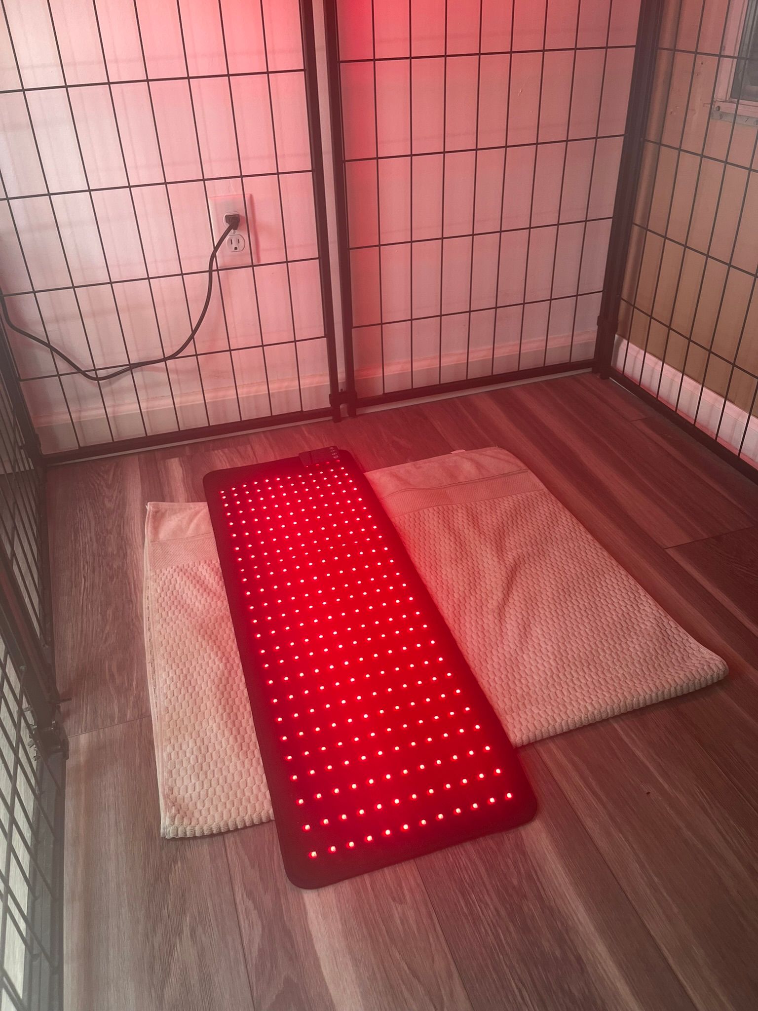 A red mat is sitting on the floor in a room