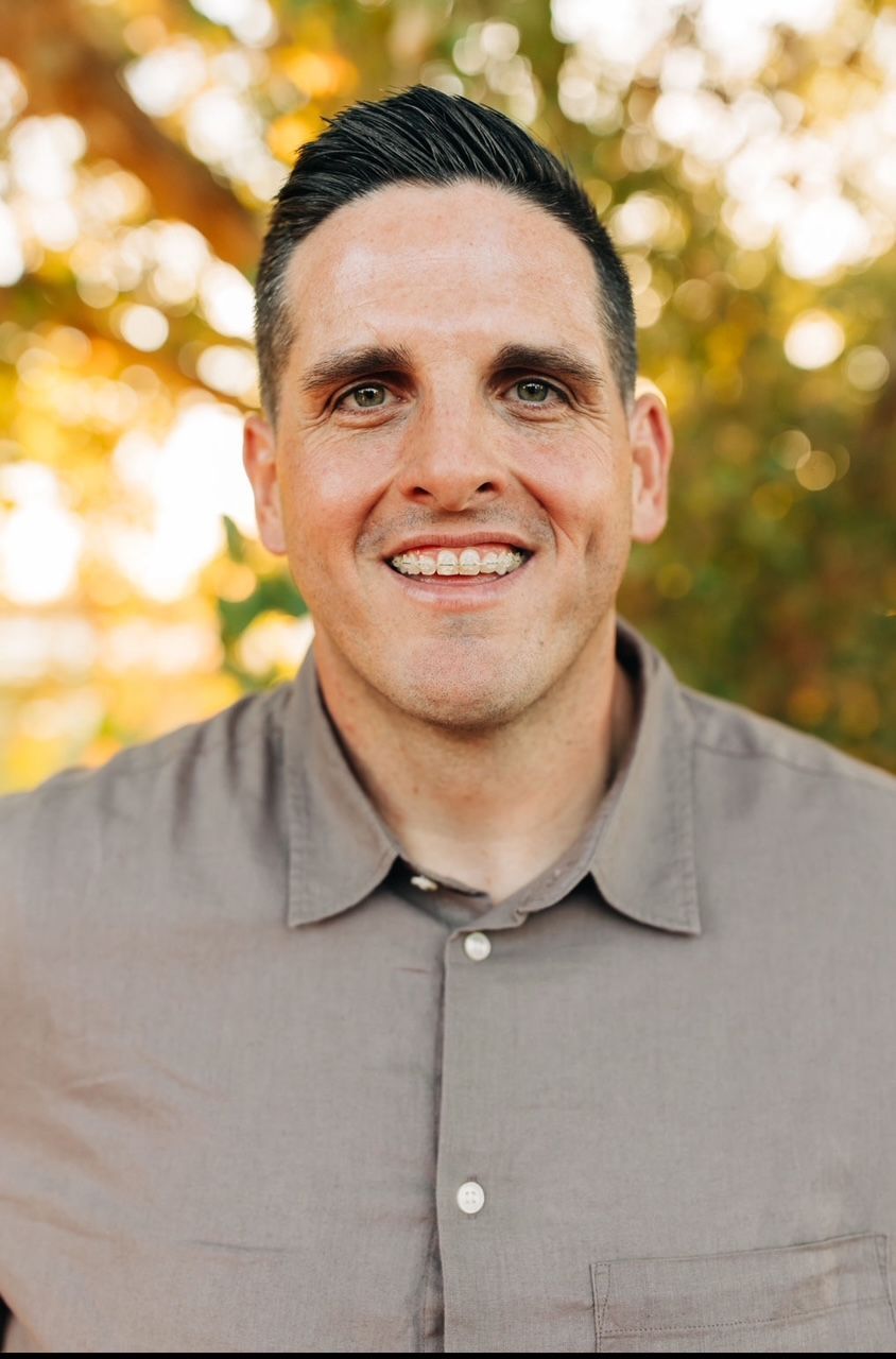 A white merrill truck is parked in a parking lot