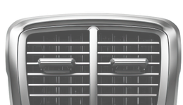 Close-up of a silver car grille with a central emblem and horizontal chrome bars. | Mario’s Automotive
