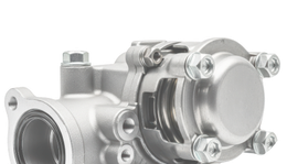 Silver metal mechanical valve component with bolts and a round cap on a white background | Mario’s Automotive