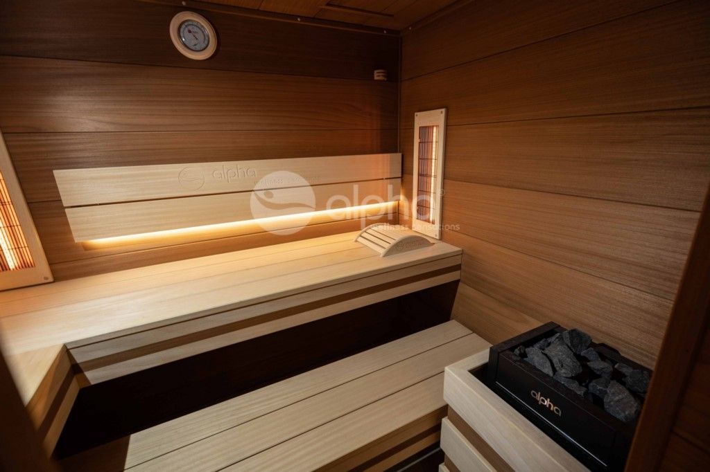 Un sauna en bois avec un banc et un poêle.