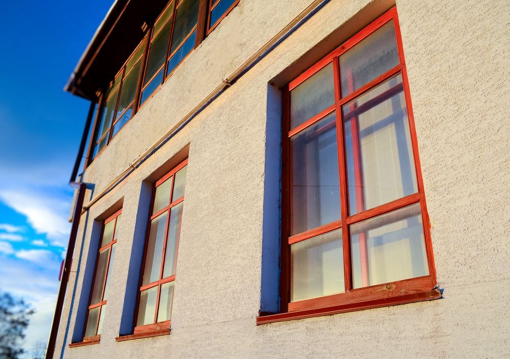 Building Exterior With Red-framed Windows Against a Bright Blue Sky — Working Windows in Byron Bay, NSW