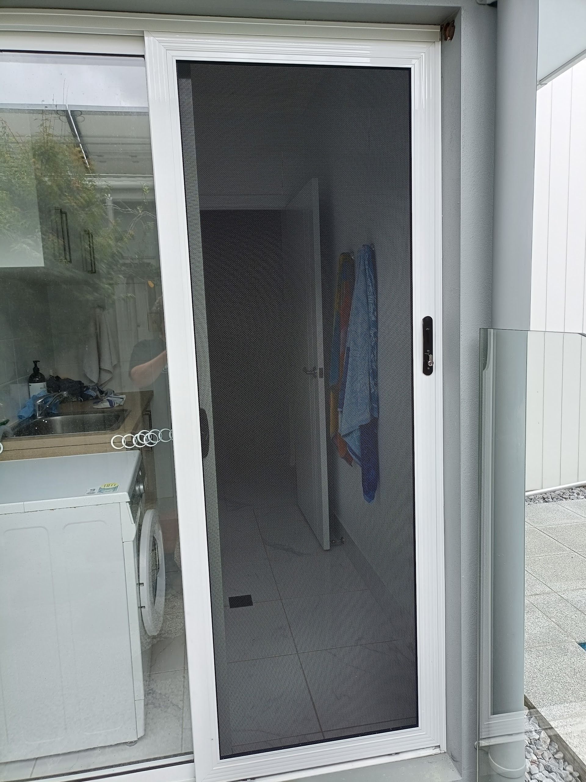 White-framed Sliding Screen Door, Partially Open — Working Windows in Ballina, NSW