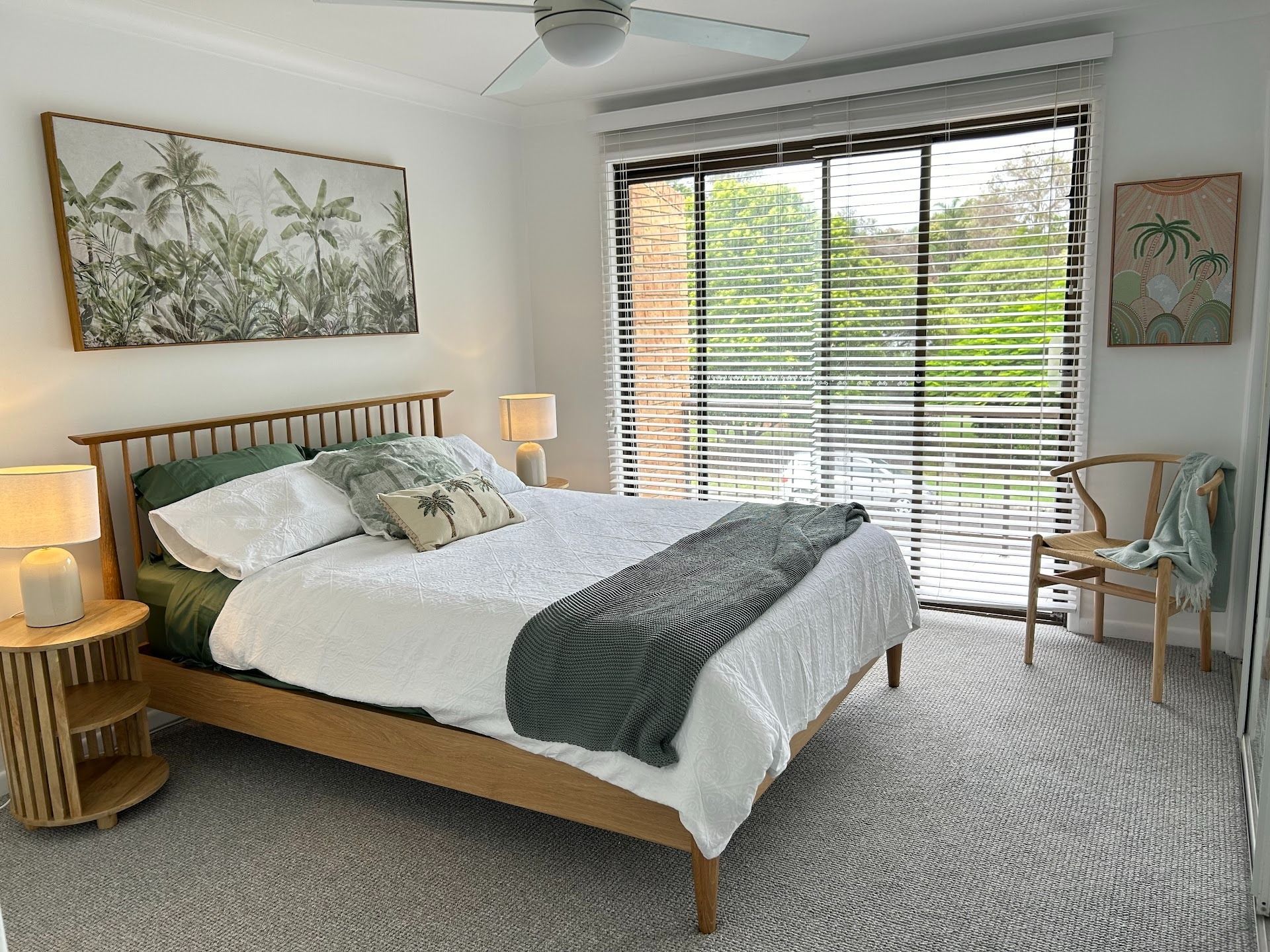 Bedroom With a Wooden Bed, Art, Large Window With Blinds, and Rug — Working Windows in Byron Bay, NSW