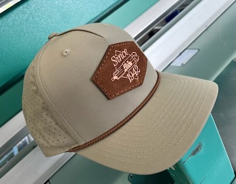 Tan baseball cap with brown leather patch featuring 