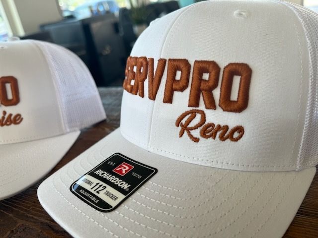 White SERVPRO hat with brown embroidered letters and a 