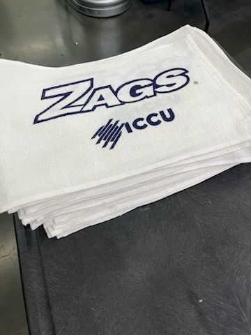 White towels stacked, embroidered with 