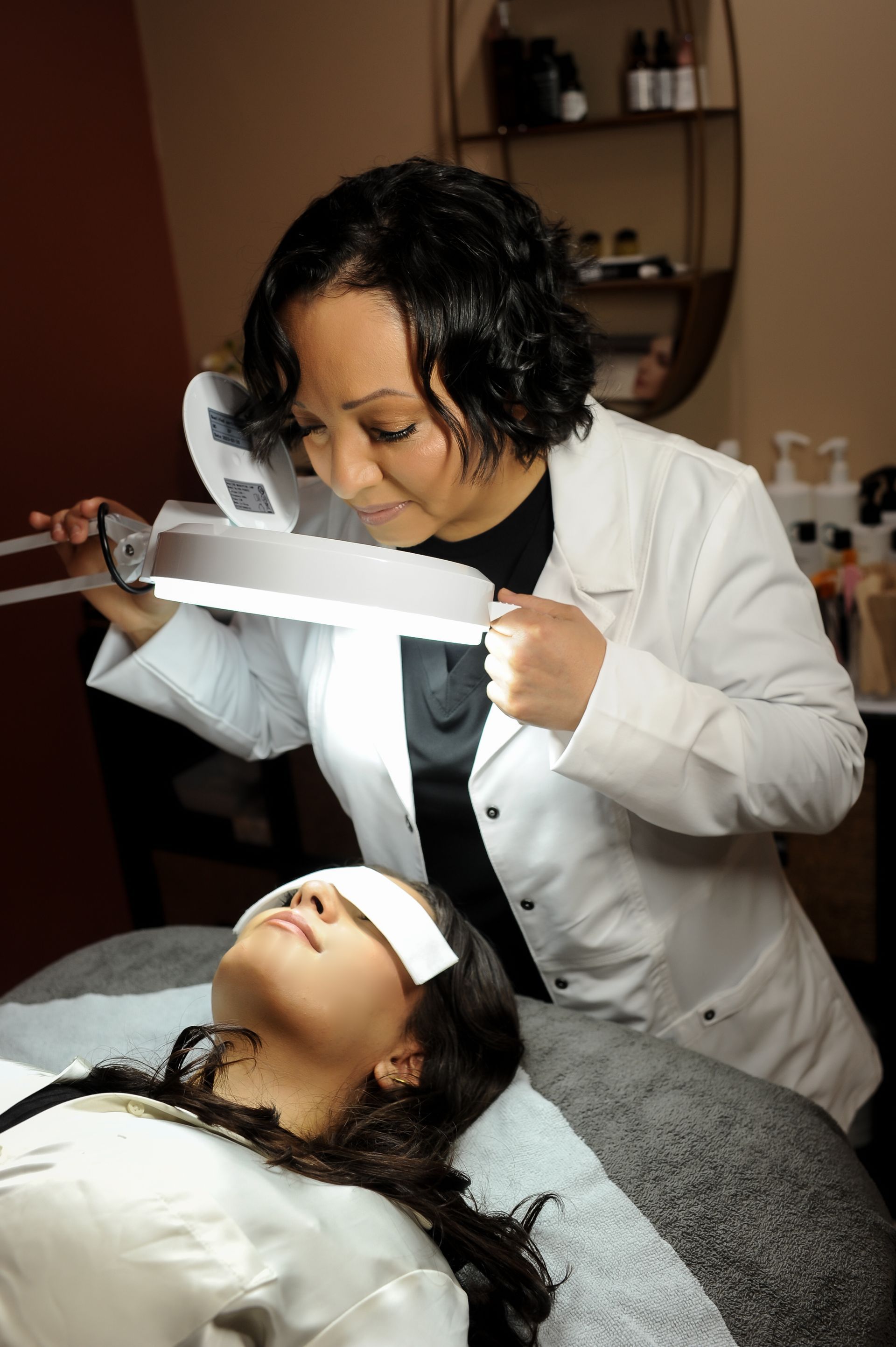 A woman is getting a hair treatment at a beauty salon.