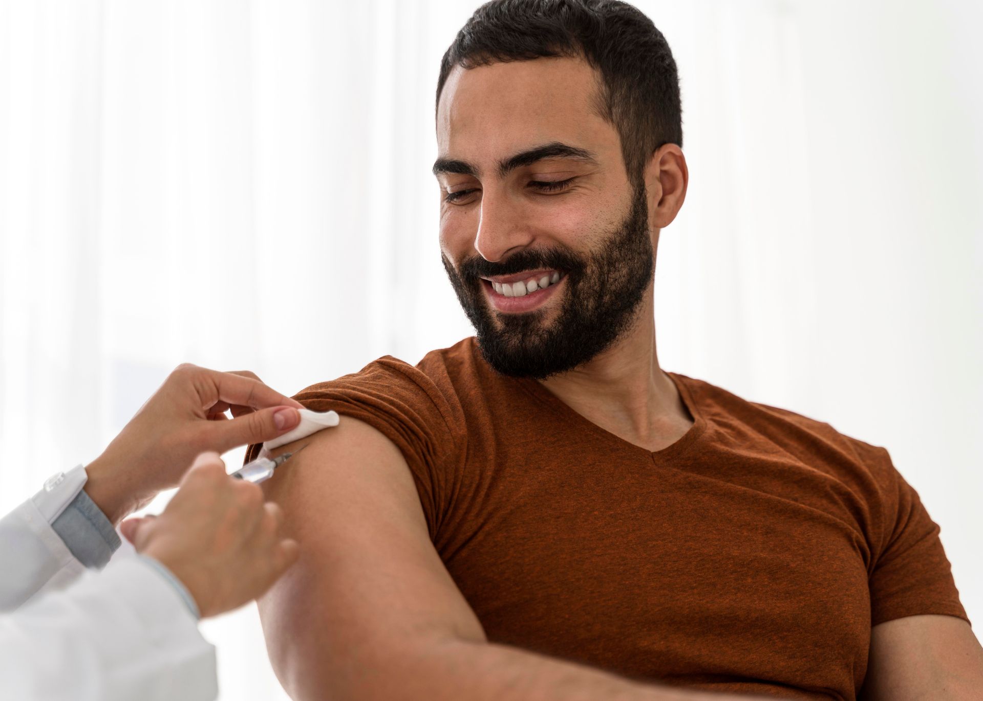 A woman is getting an injection in her arm from a doctor.