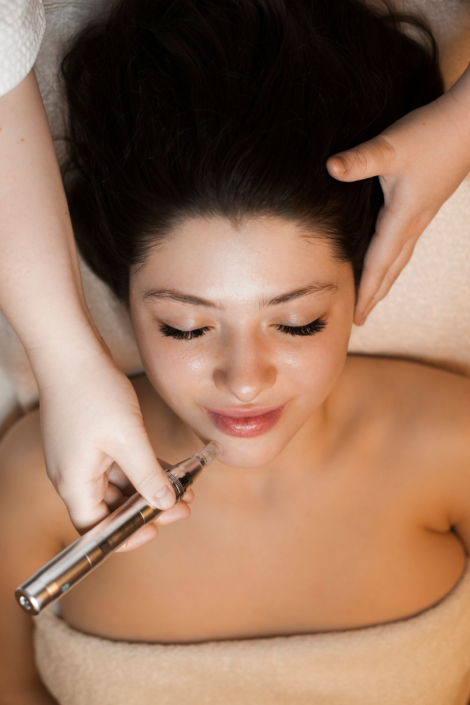 A woman is getting a facial treatment at a spa.