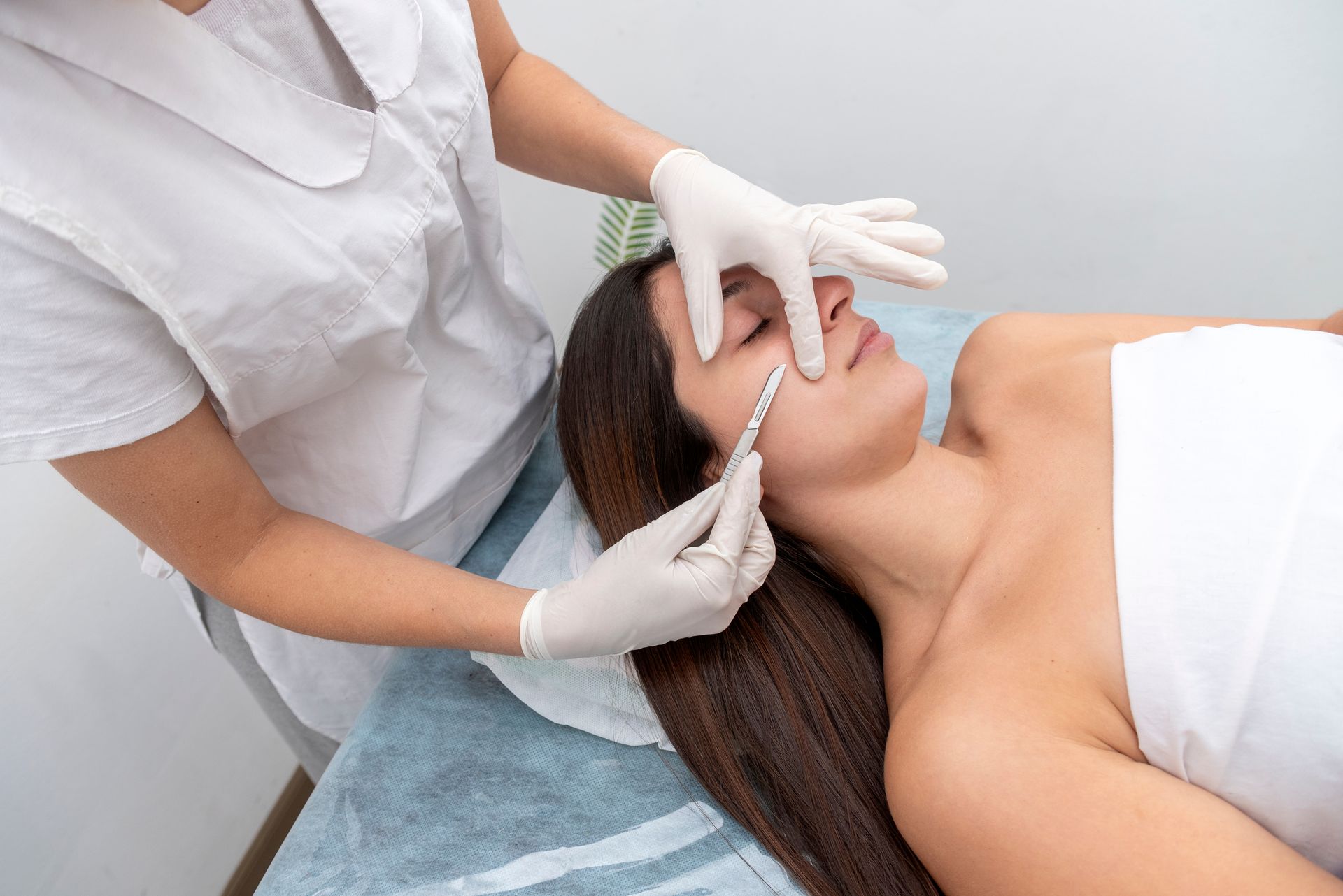 A woman is getting an injection in her face in a beauty salon.