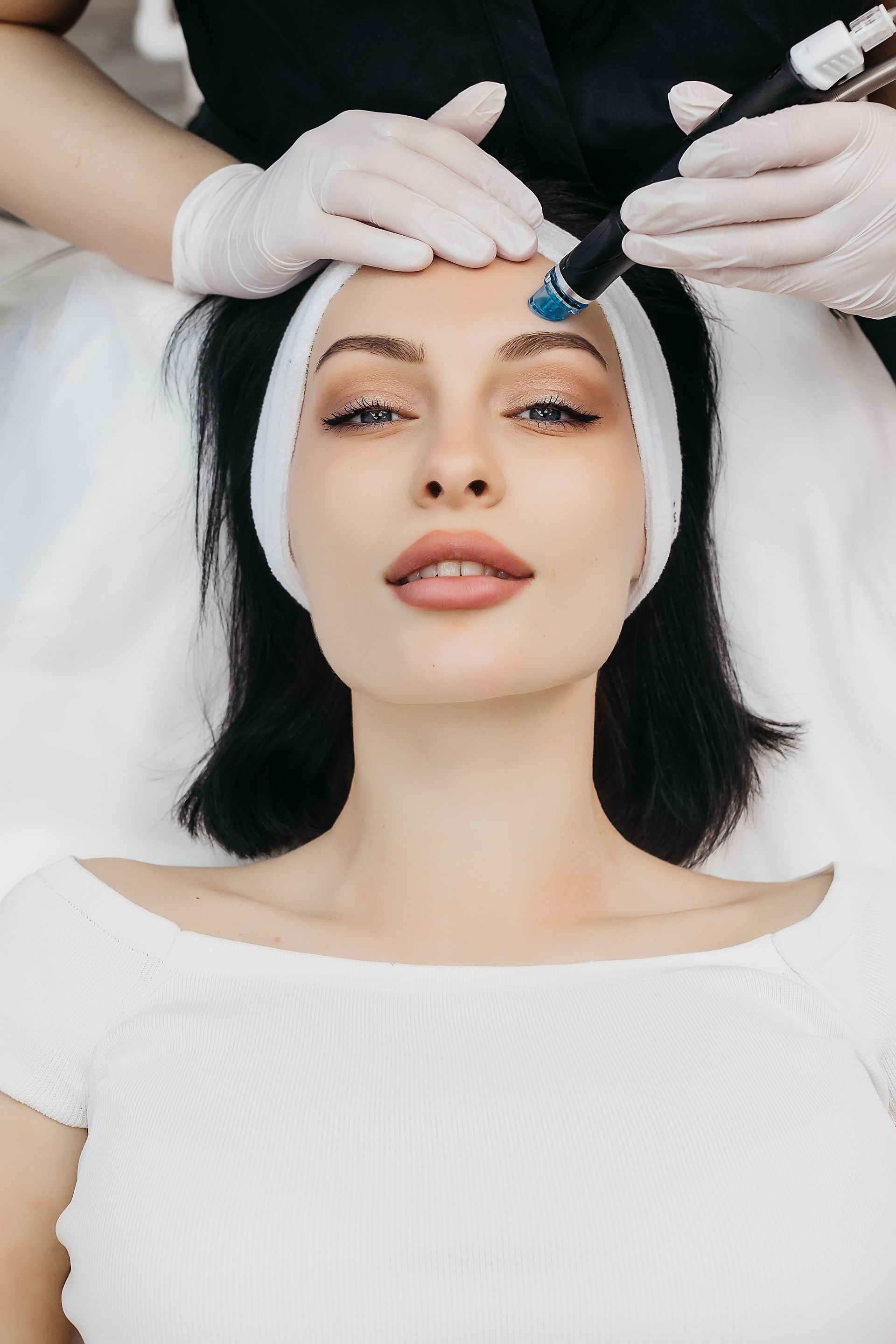 A woman is getting a facial treatment at a beauty salon.