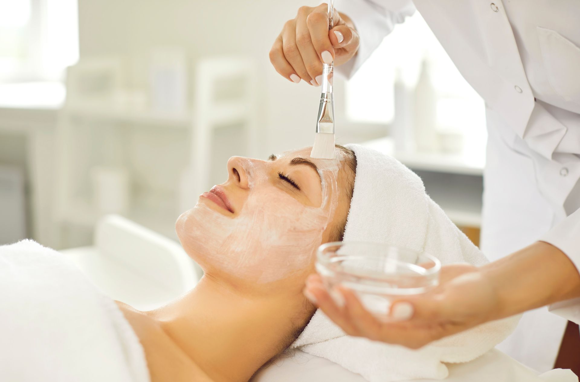 A woman is getting a facial treatment at a spa.