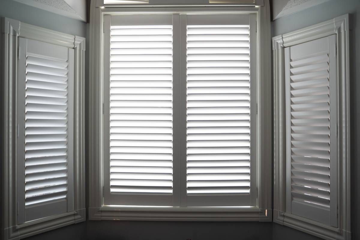 White interior shutters on three windows at Julie Muscato Home & Gifts near Lockport, New York (NY)