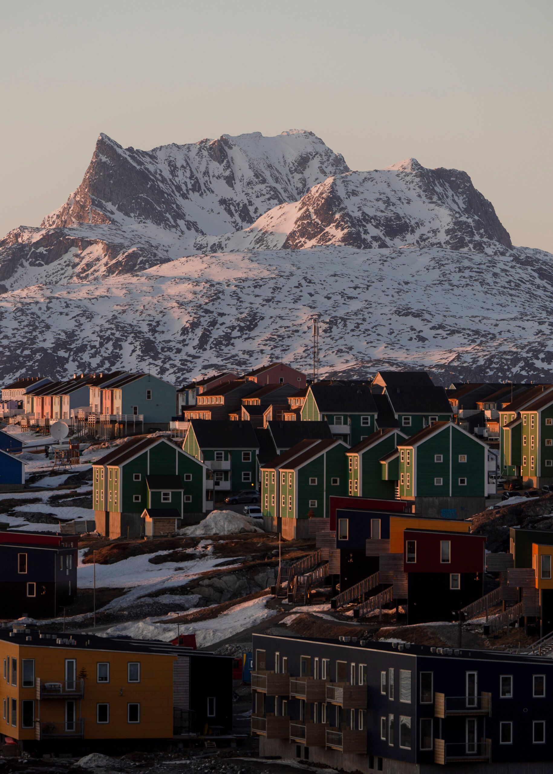 A city with a mountain in the background and houses in the foreground