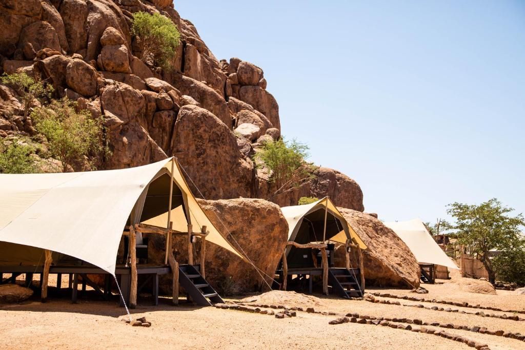 A group of tents are sitting in the middle of a desert.