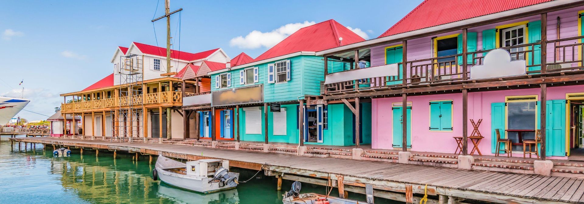 A row of colorful buildings sitting next to a body of water.