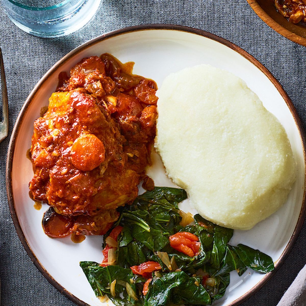 A plate of food with mashed potatoes and vegetables on a table.