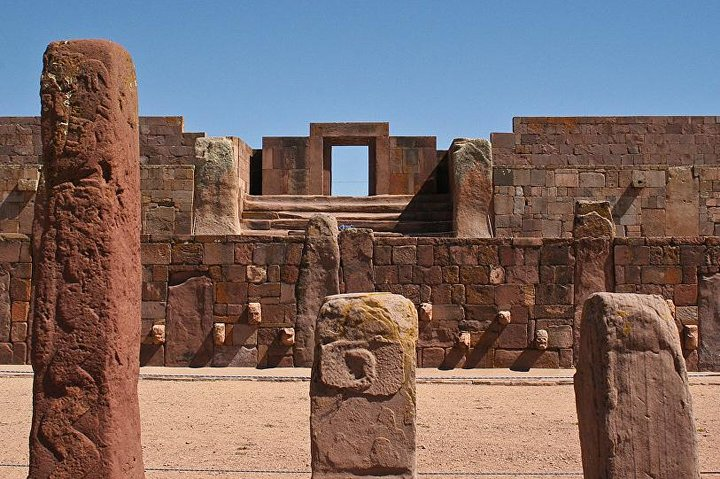 A row of stone pillars in front of a stone building