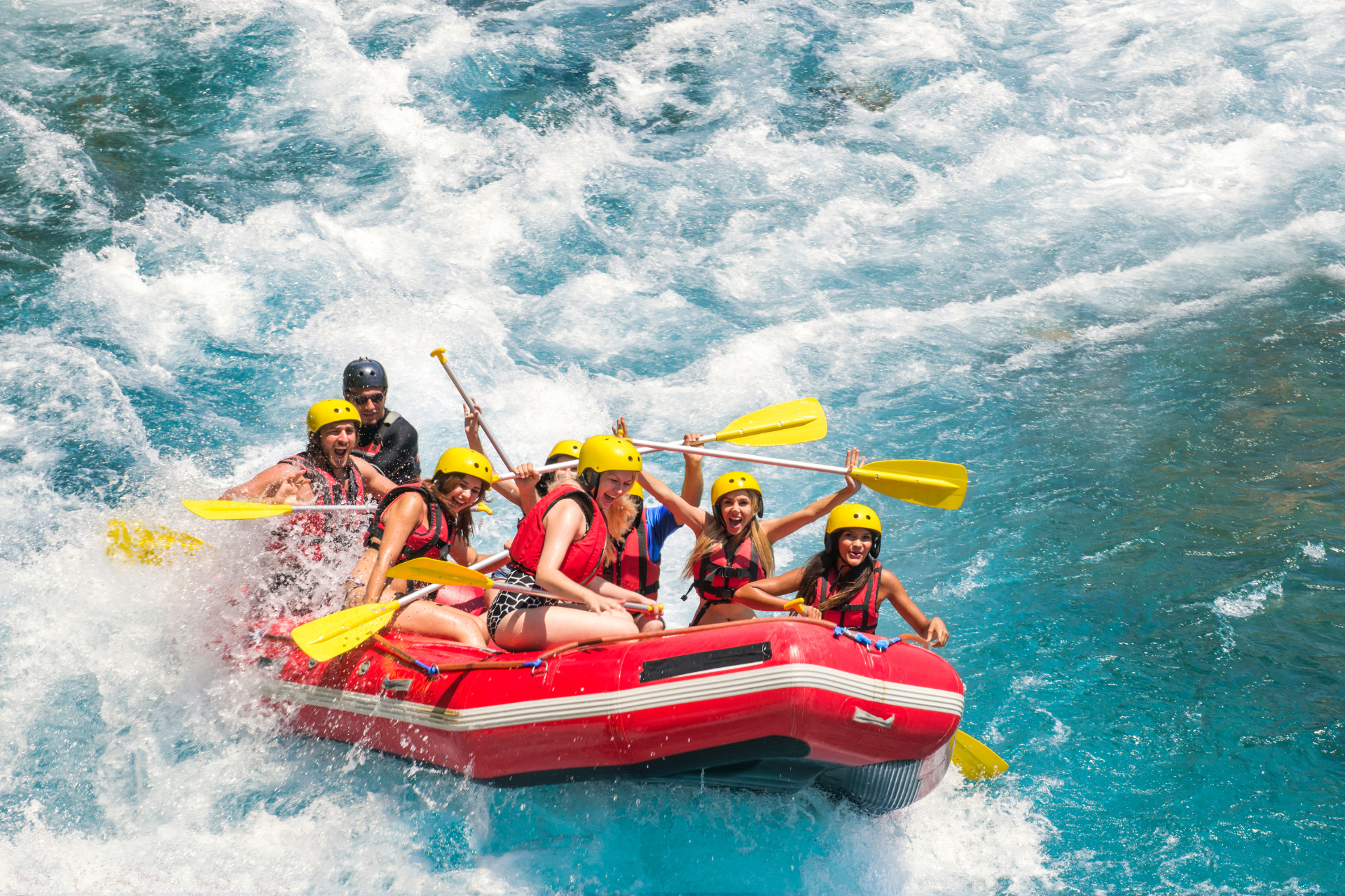 A group of people are rafting down a river in a raft.