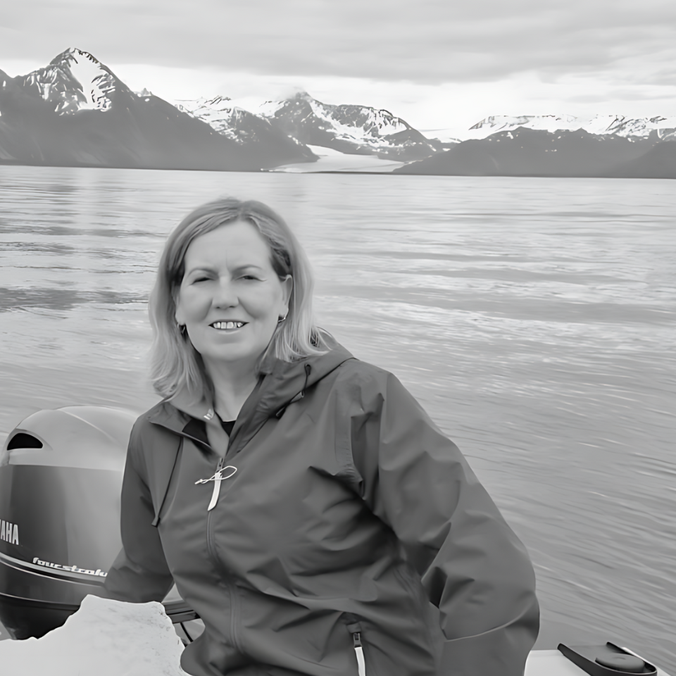 A black and white photo of a woman on a boat