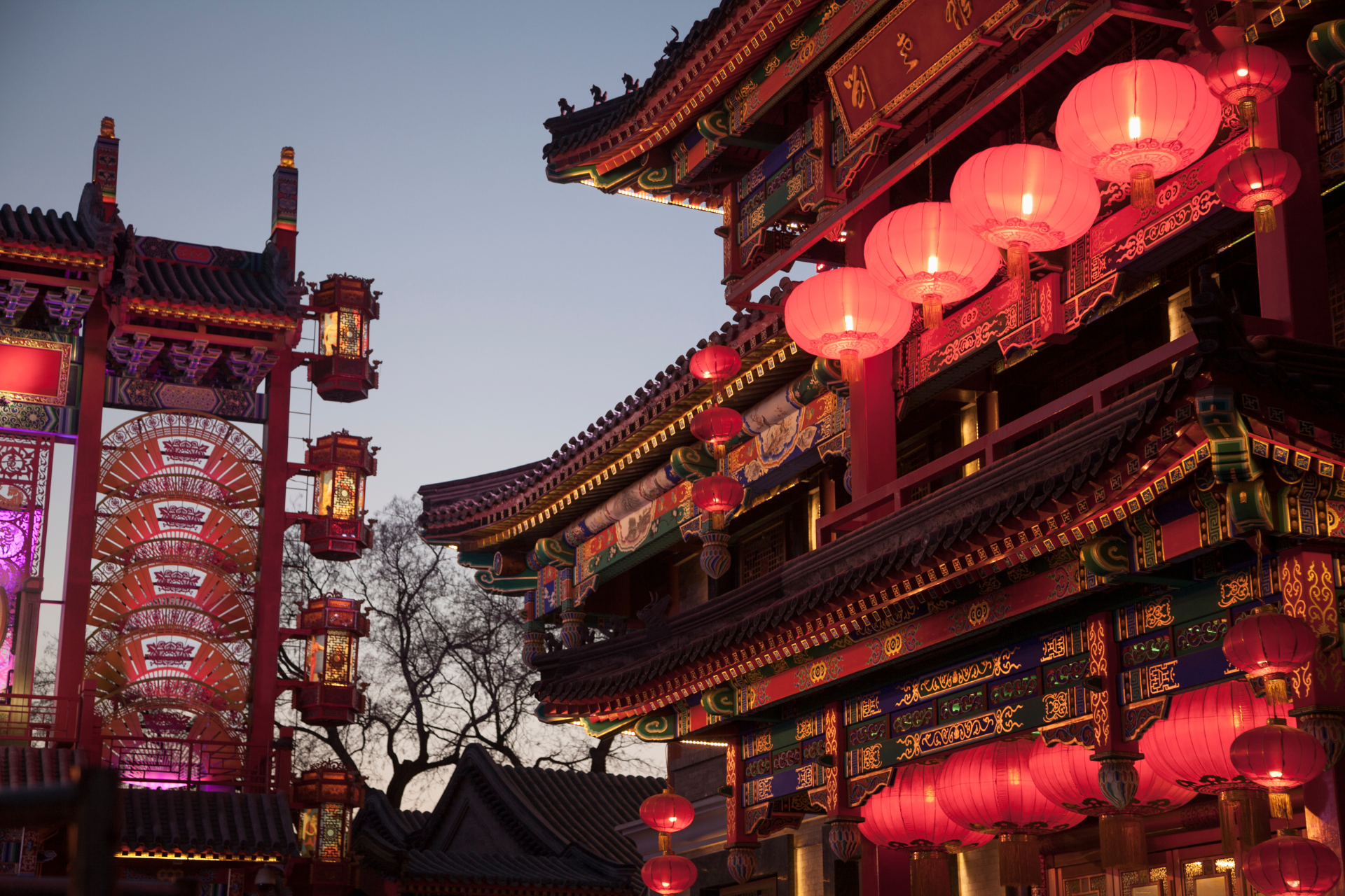 A chinese building with red lanterns hanging from the roof