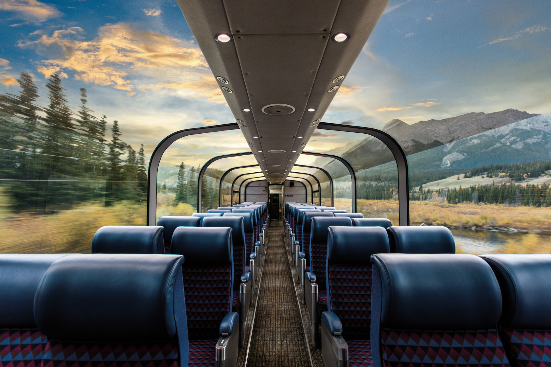 The inside of a train car with mountains in the background.