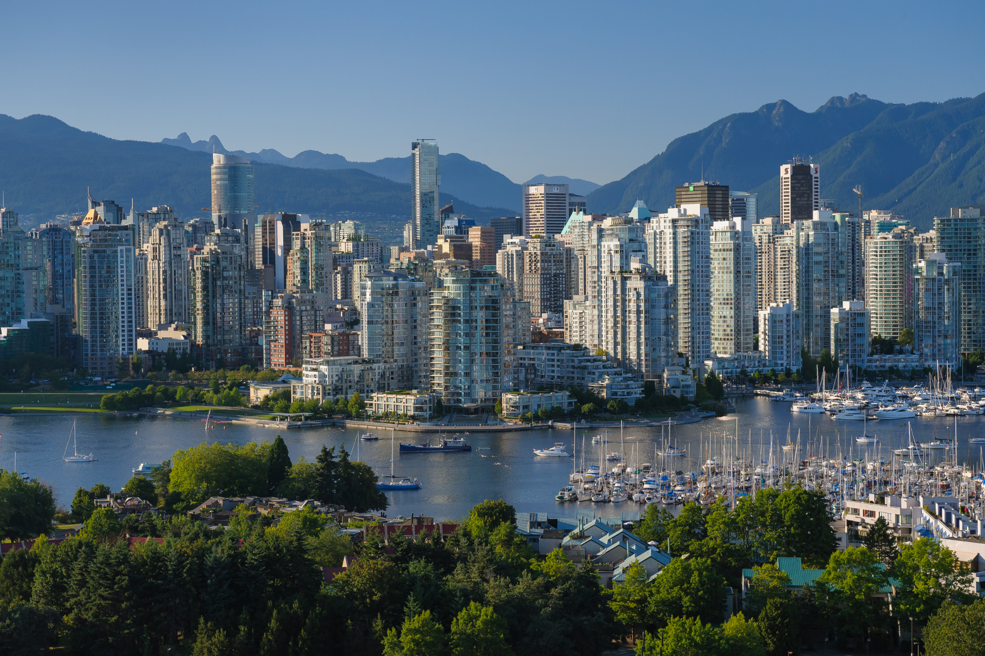 An aerial view of a city with mountains in the background