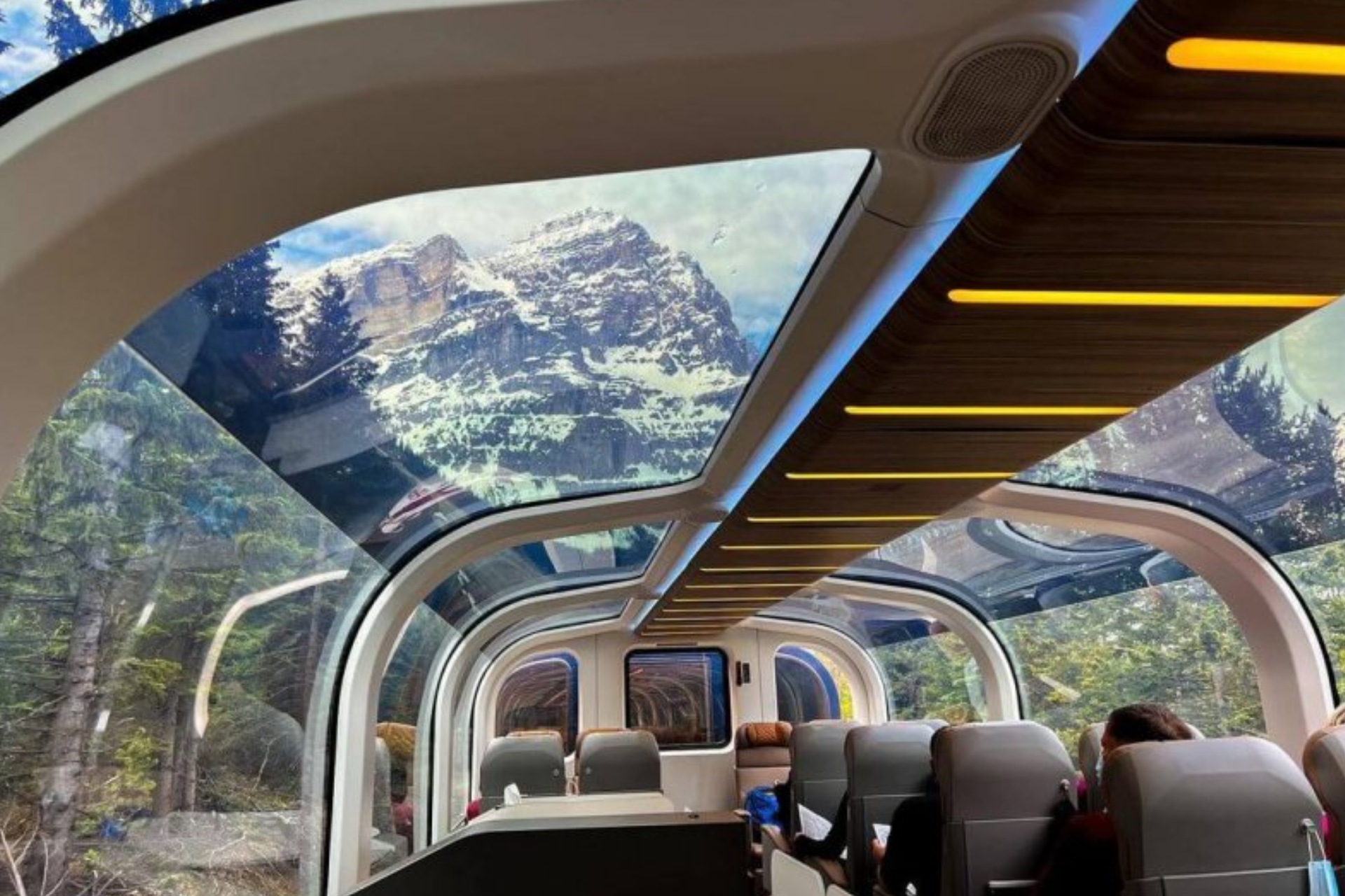 The inside of a train car with a mountain in the background