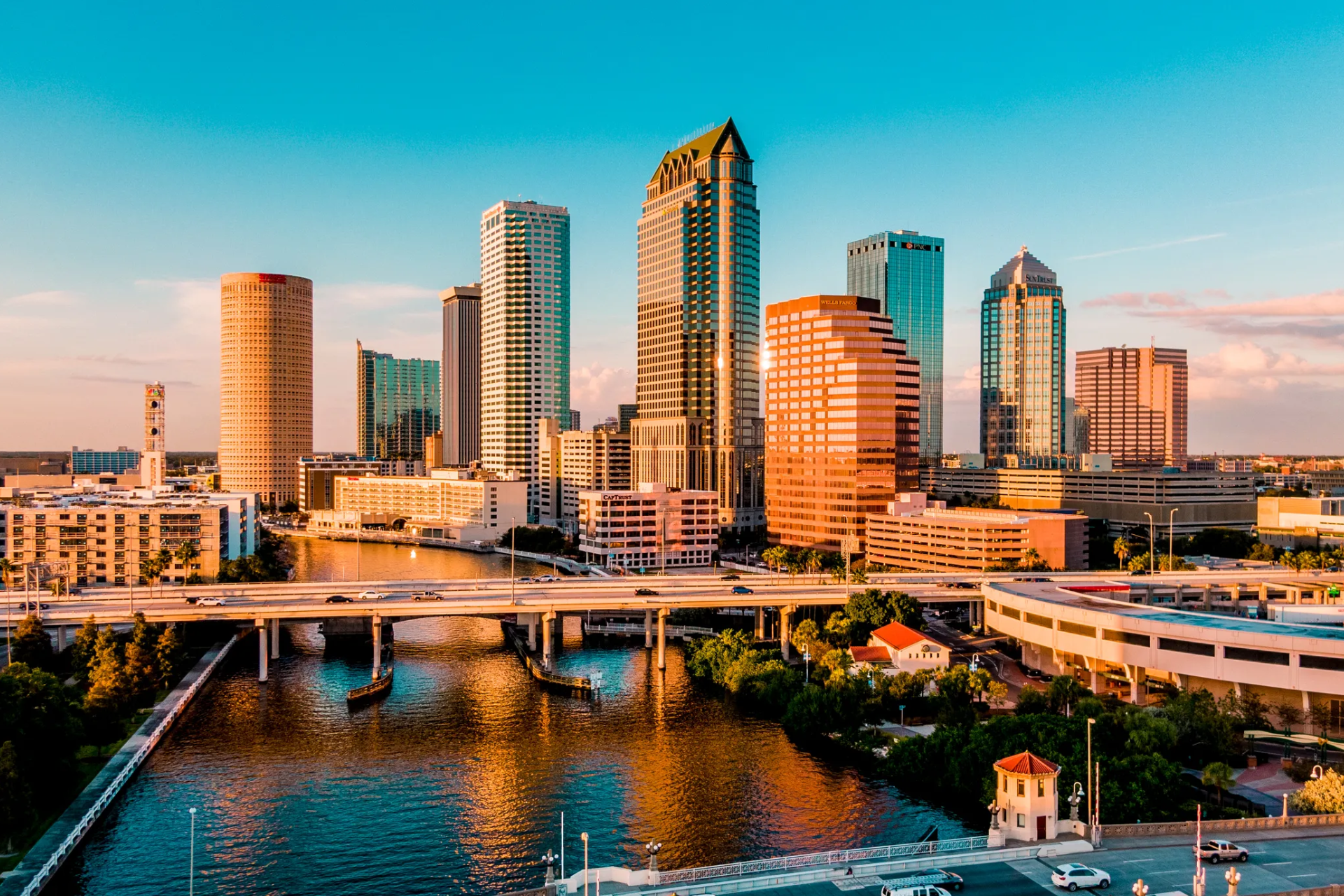 An aerial view of a city skyline with a river in the foreground.