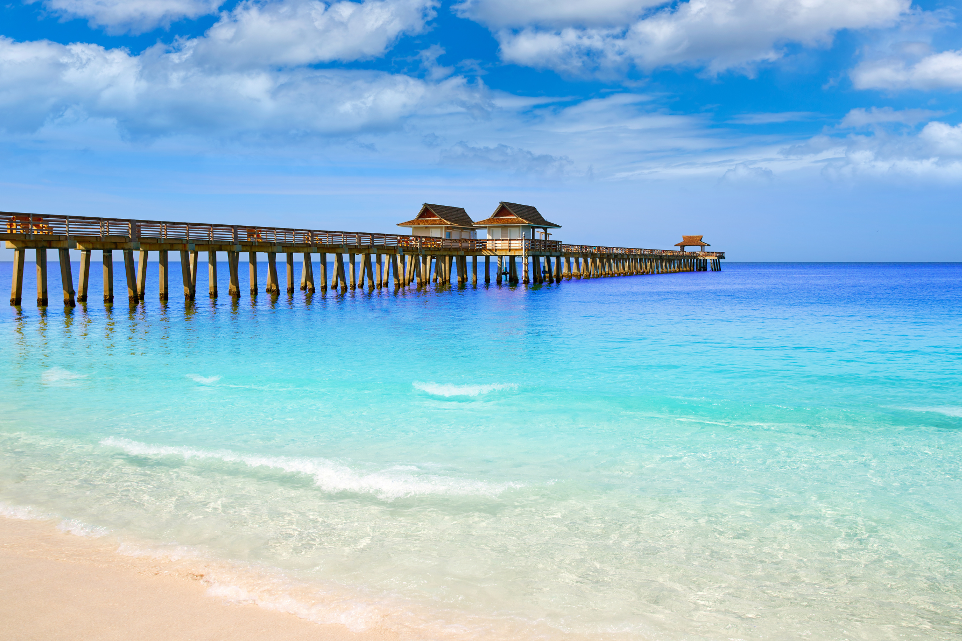 There is a pier in the middle of the ocean.