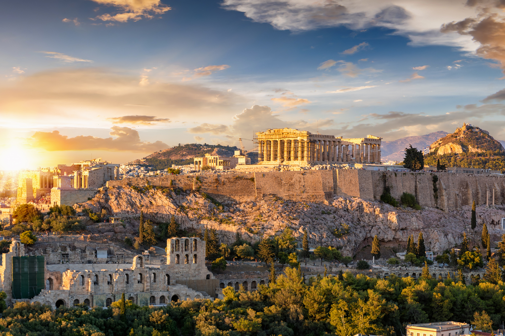 An aerial view of the acropolis of athens at sunset.