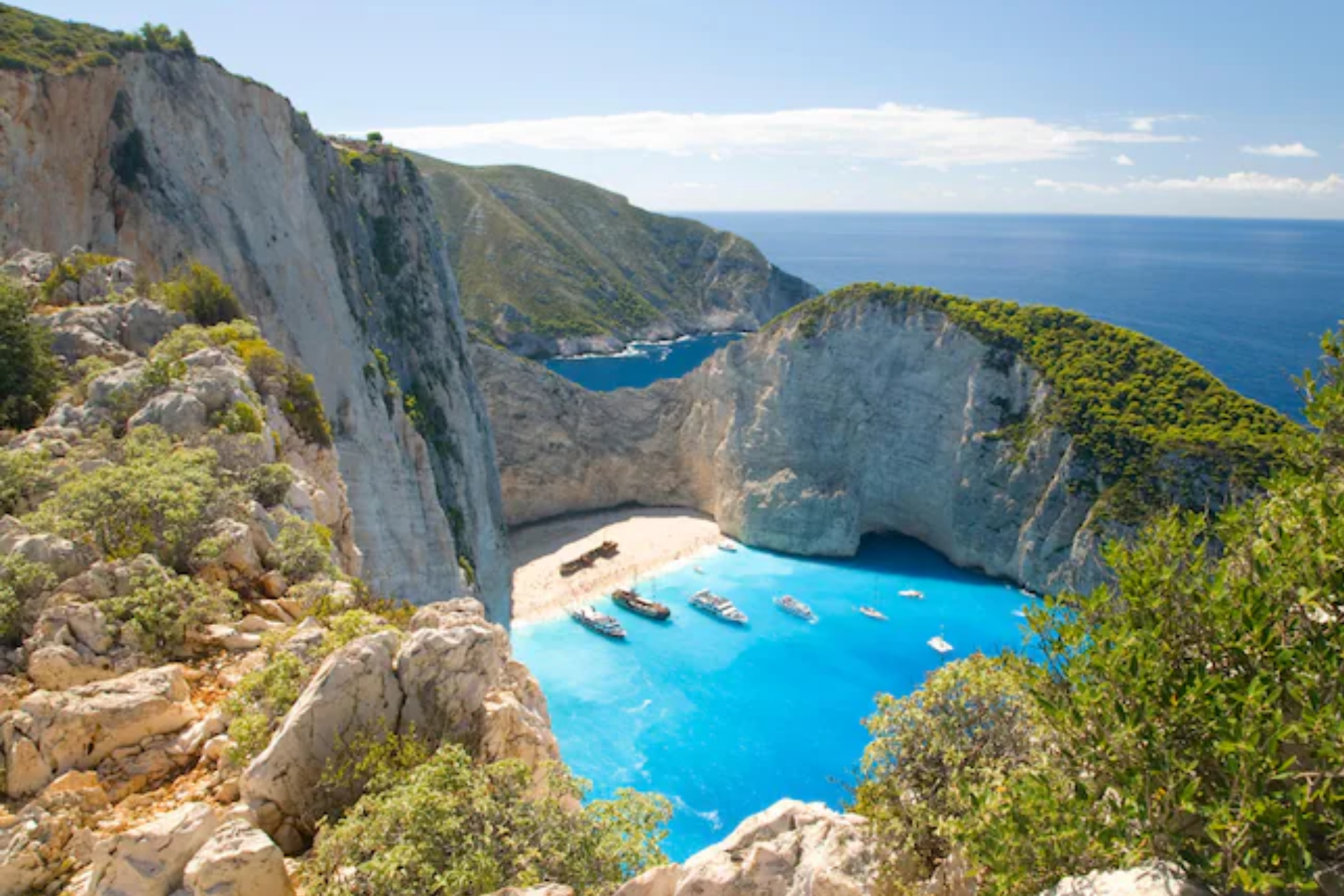 A large body of water surrounded by rocks and trees.