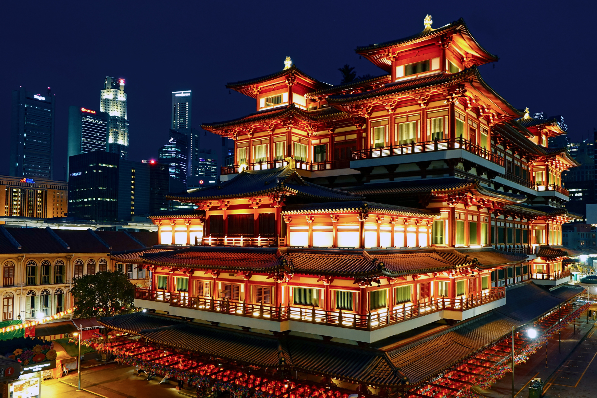 A large building is lit up at night in a city