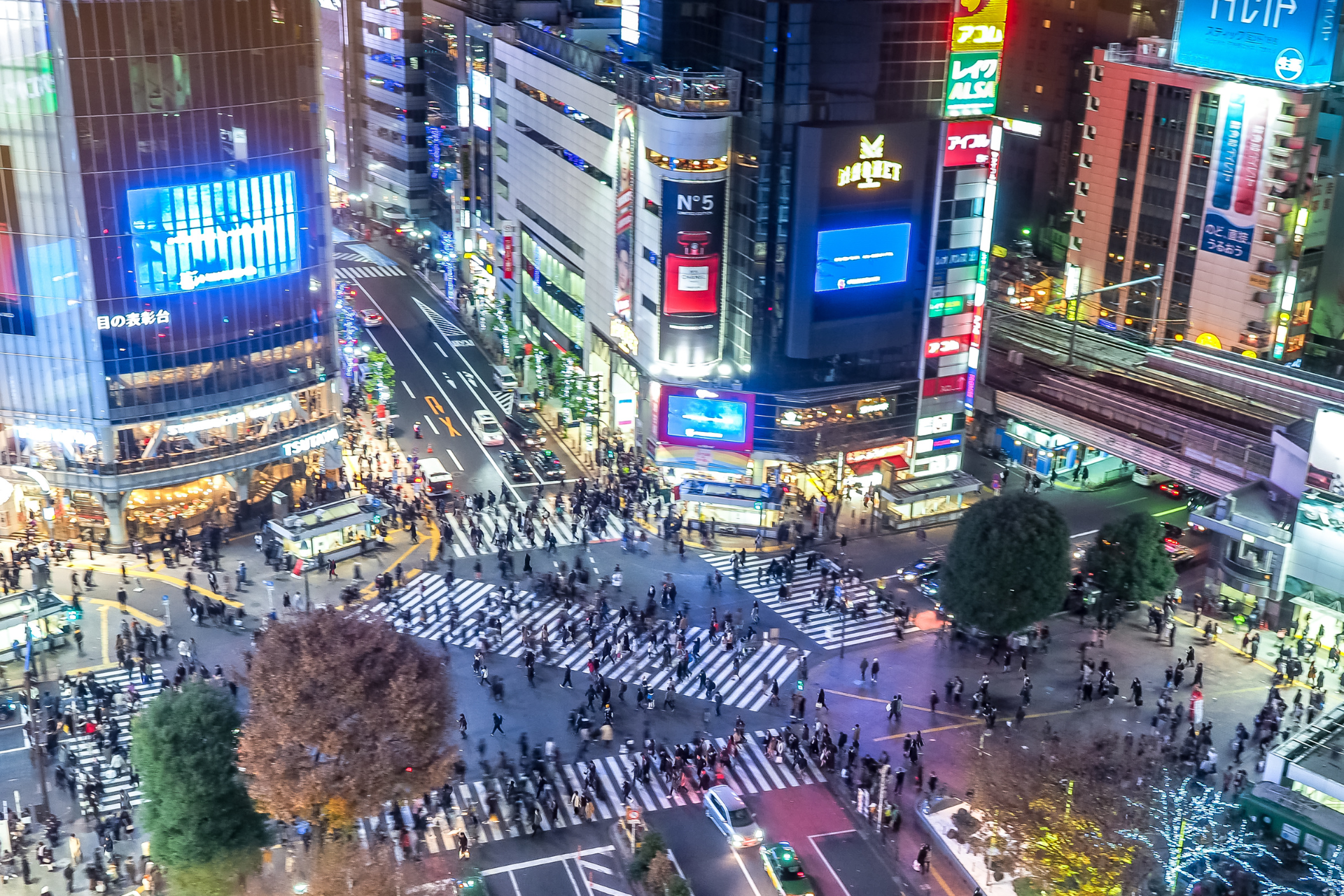 An aerial view of a crowded intersection in a city at night.