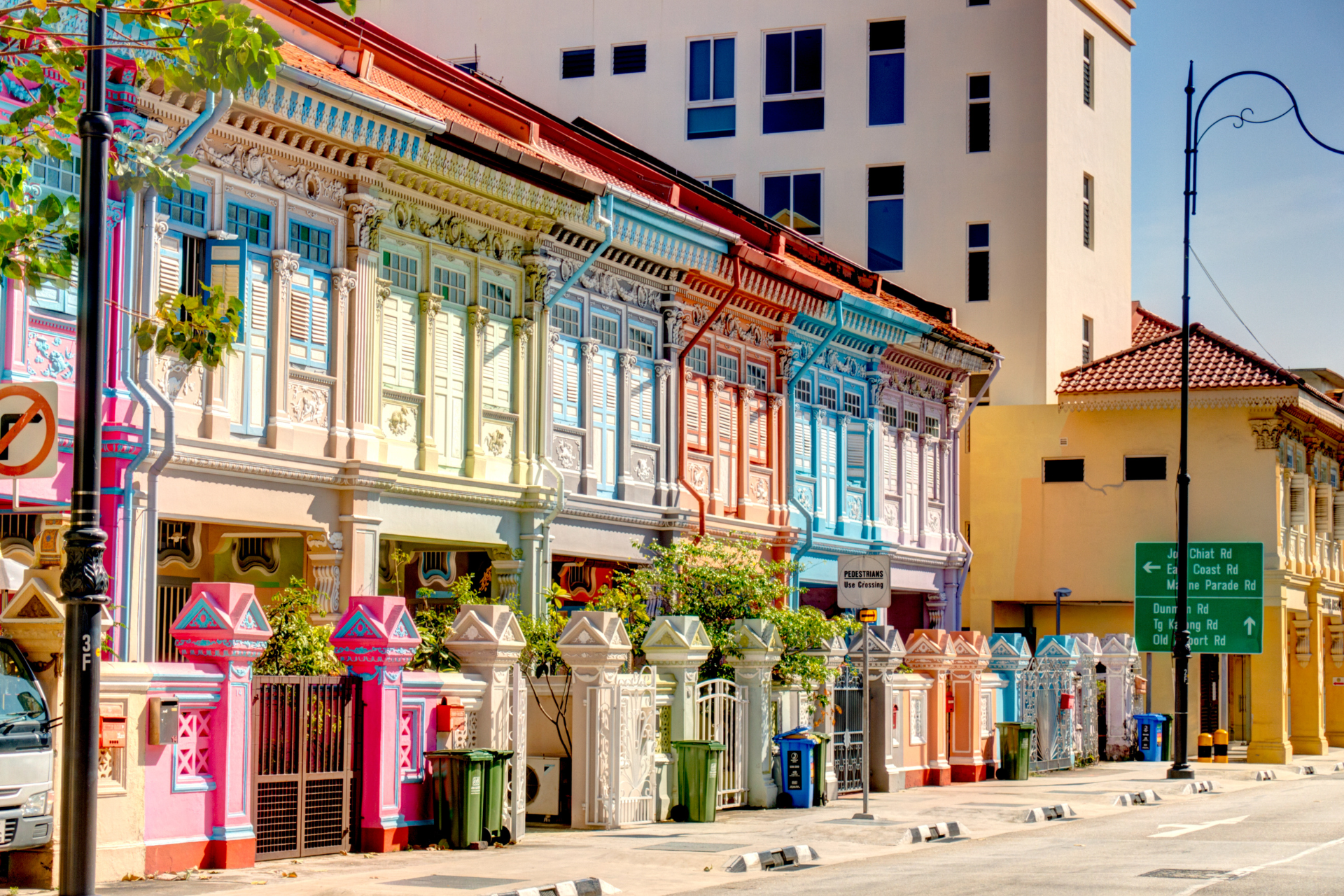 A row of colorful buildings are lined up on a city street.