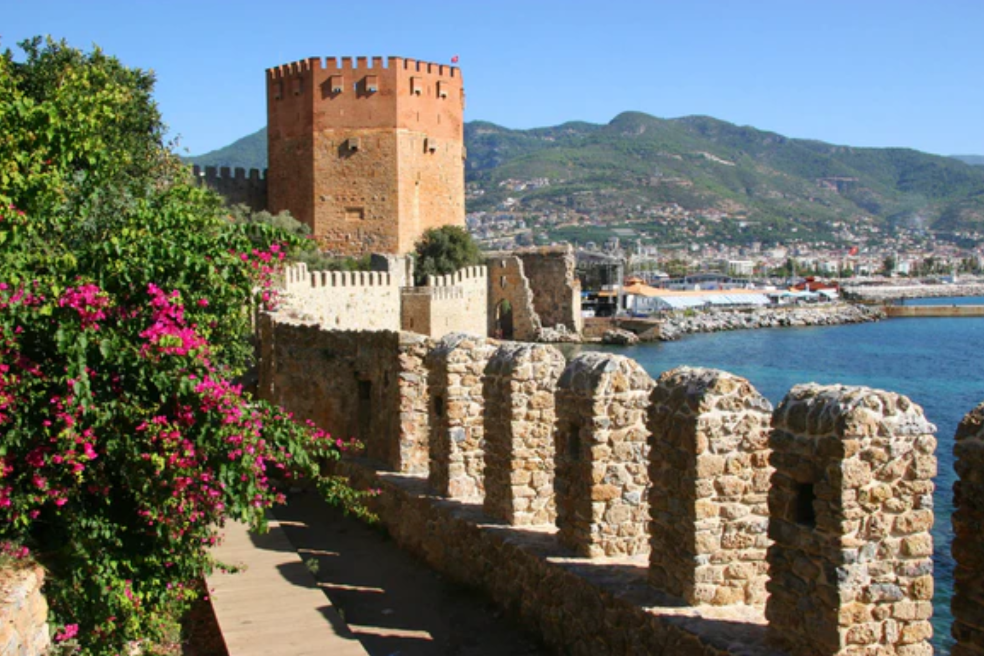 A stone wall with a tower in the background