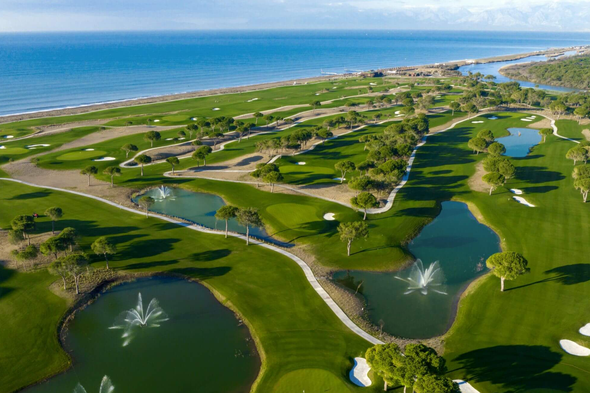 An aerial view of a golf course next to the ocean.