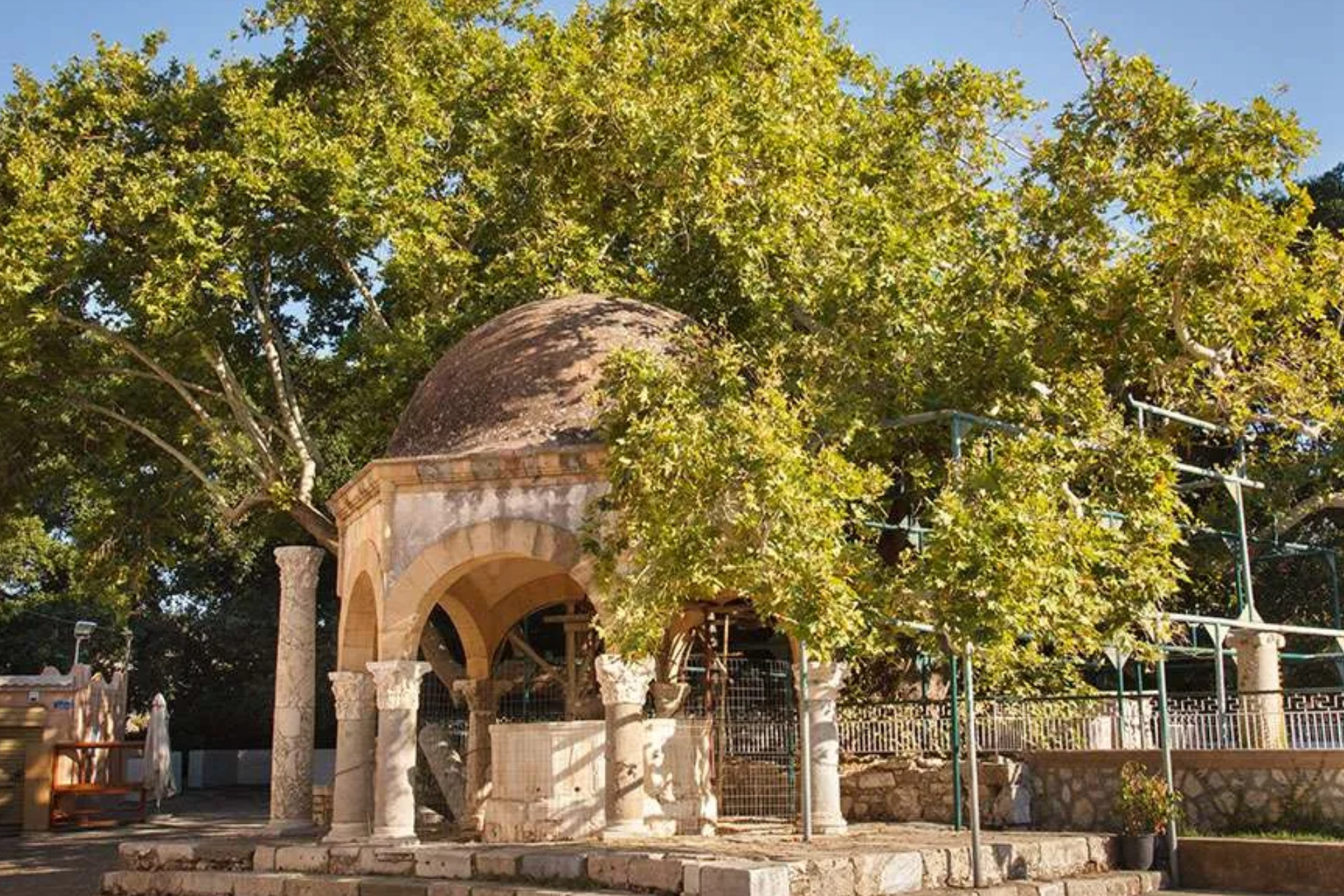 A building with a dome on top of it is surrounded by trees.