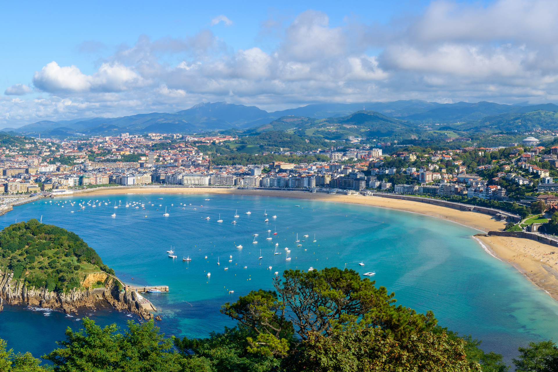 An aerial view of a large body of water with a city in the background.