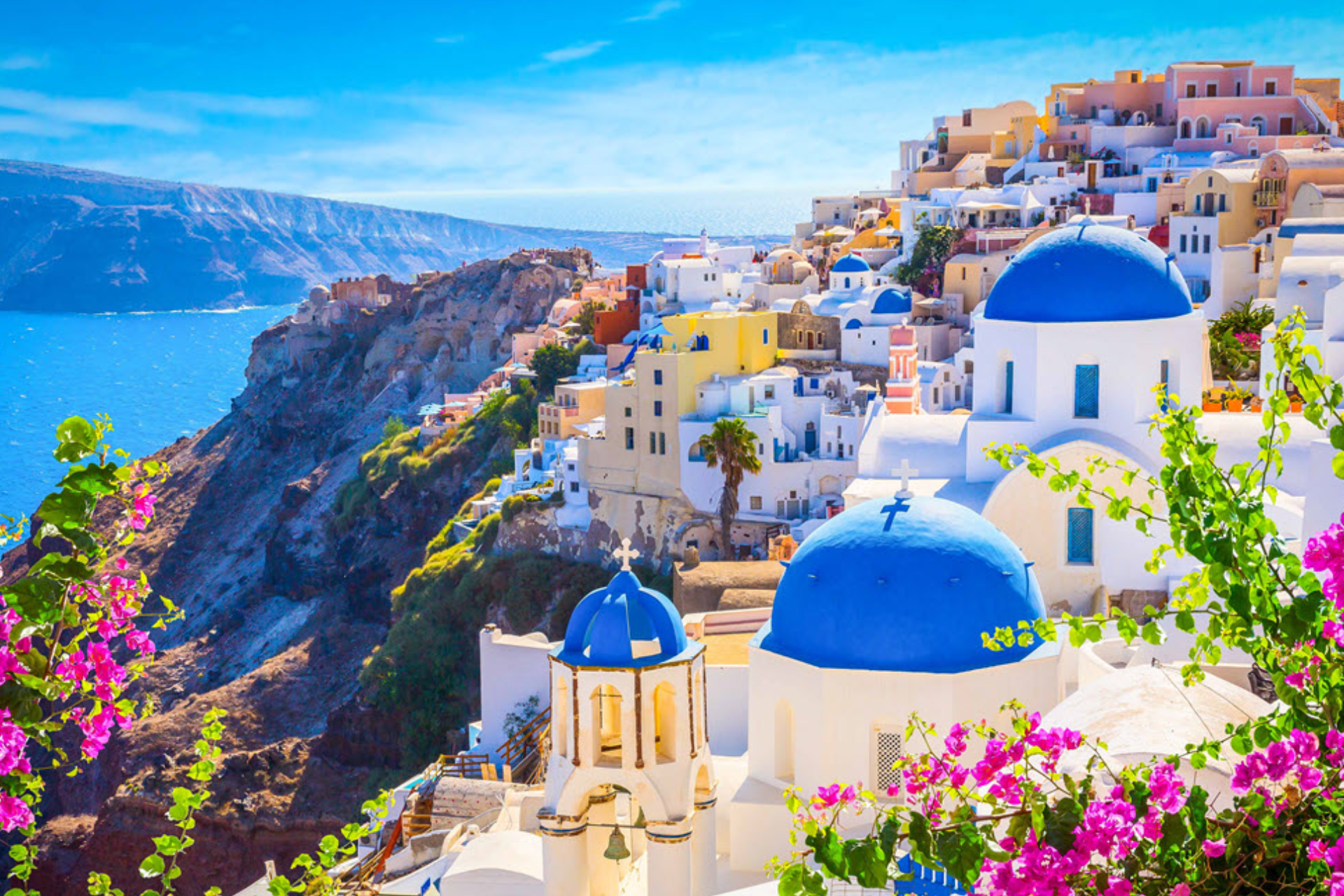 A painting of santorini , greece with blue domes and pink flowers.