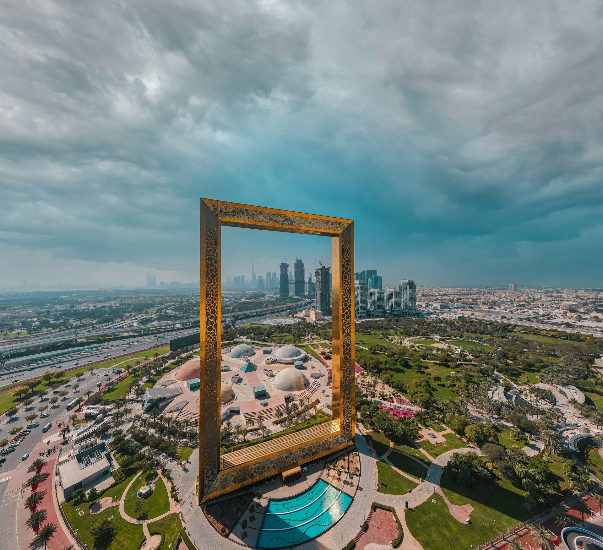 An aerial view of a city with a picture frame in the middle of it.