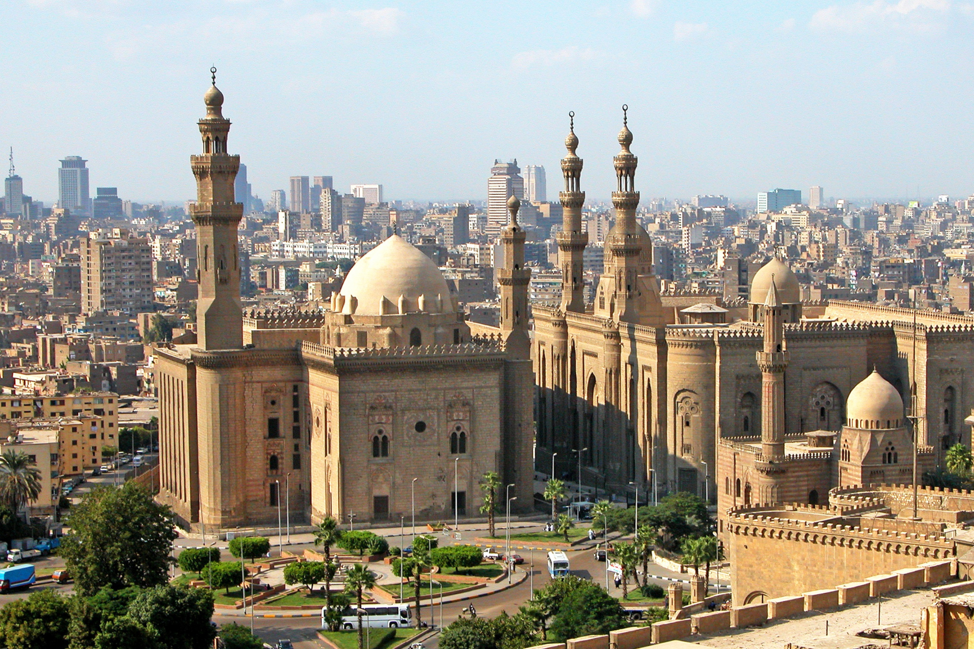 An aerial view of a city with a mosque in the foreground