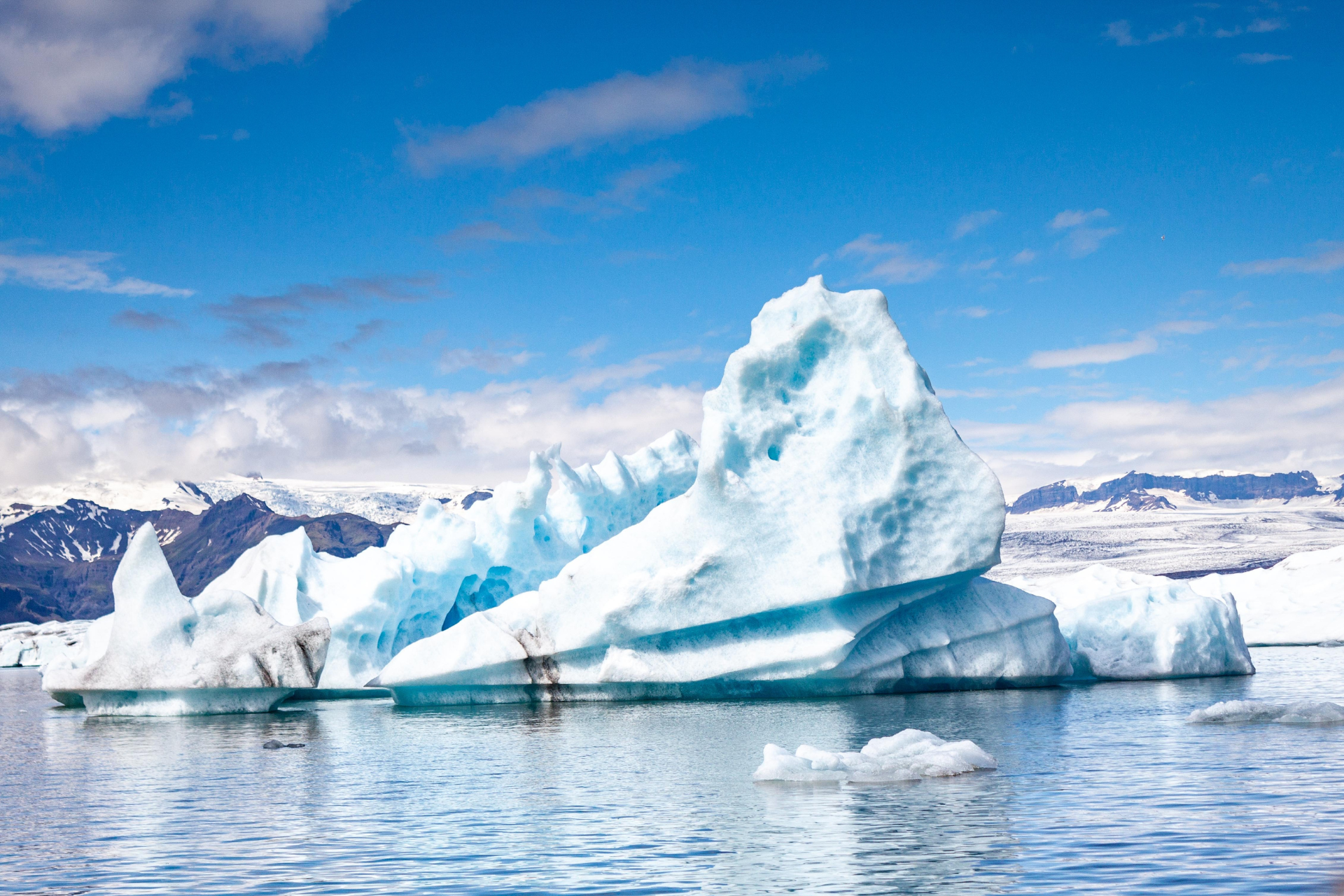 A large iceberg is floating on top of a body of water.