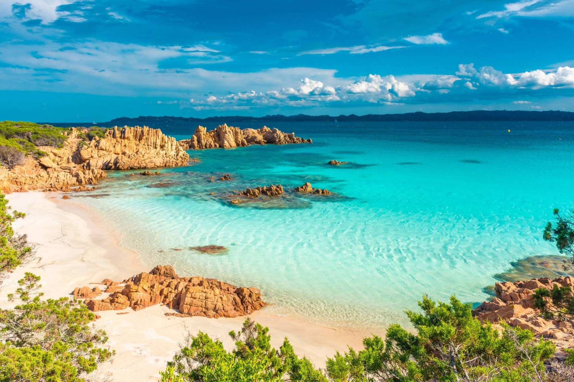 A beach with a white sandy beach and turquoise water